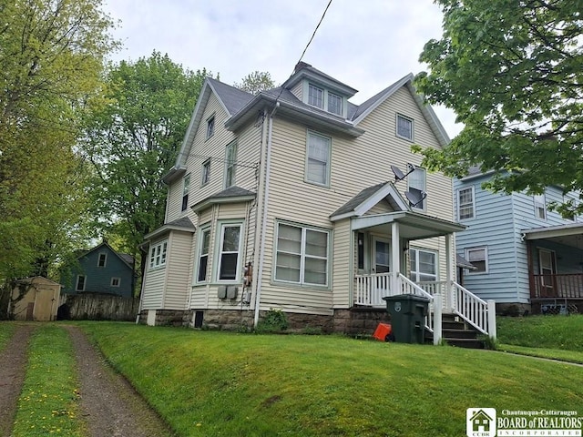 11 Prather Ave, Jamestown, NY 14701 - view of front of home with a storage unit, a front yard, an outbuilding, and a porch
