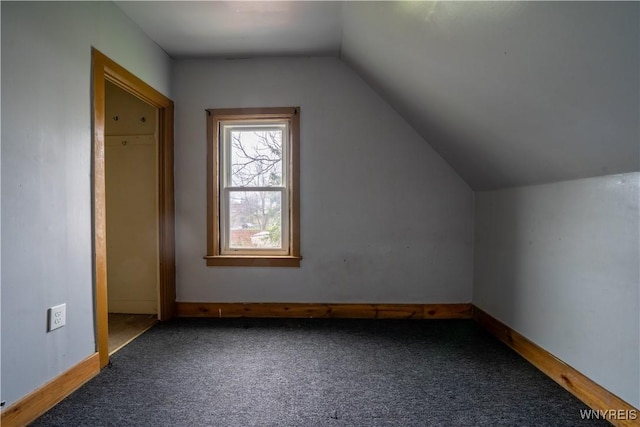 bonus room with carpet floors and vaulted ceiling