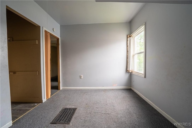 unfurnished bedroom with baseboards, carpet flooring, and a closet