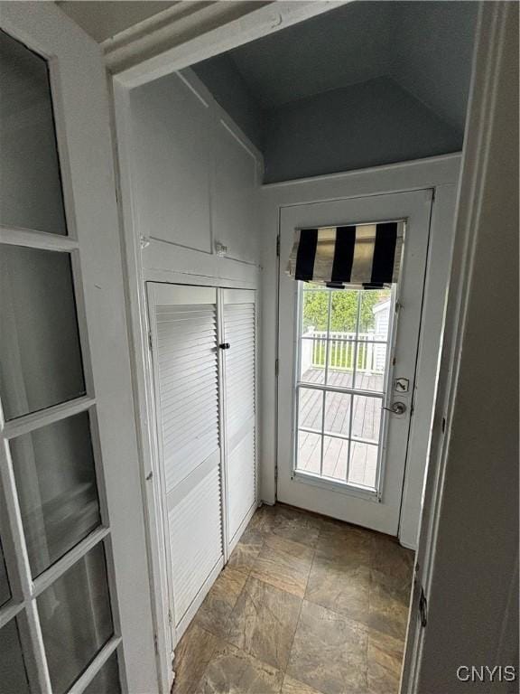 doorway to outside with stone finish flooring