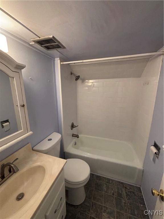 bathroom with toilet, vanity, and  shower combination