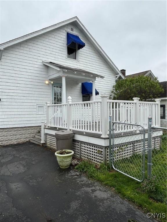 rear view of house featuring a deck