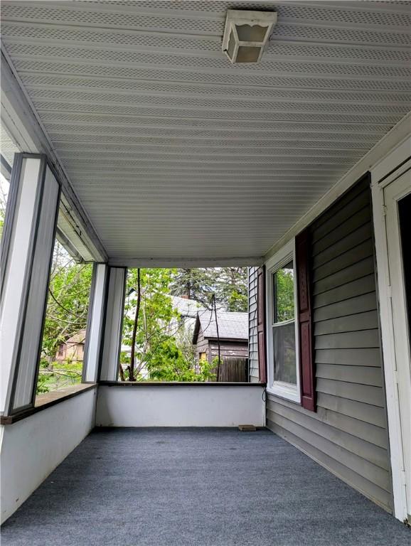 unfurnished sunroom with carpet