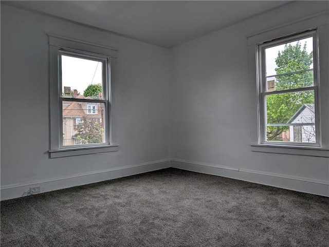 carpeted spare room with baseboards