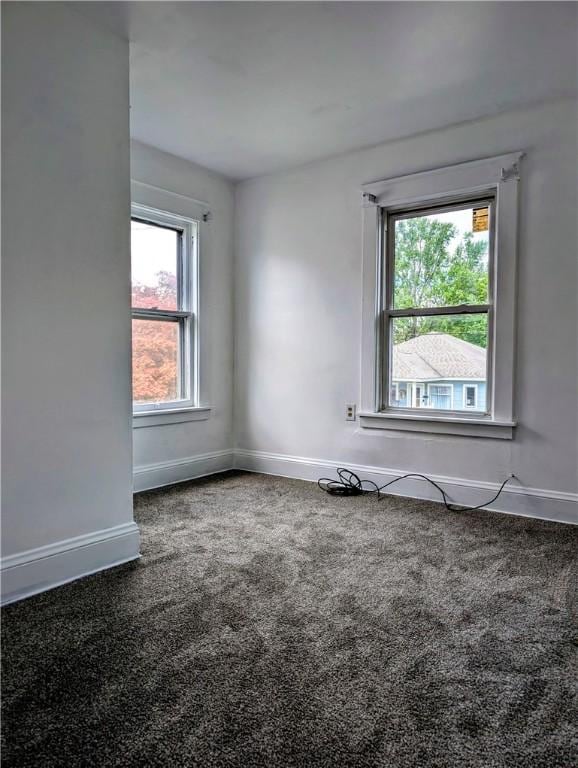 carpeted empty room with baseboards