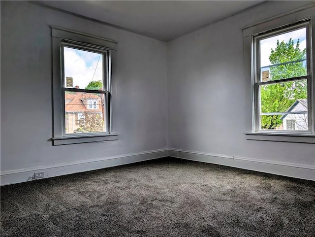 empty room featuring healthy amount of natural light and carpet