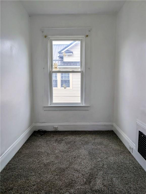 carpeted empty room with baseboards