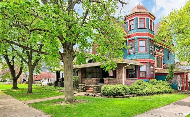 82 Clinton St, Tonawanda-City, NY 14150 - victorian-style house featuring a front yard and covered porch