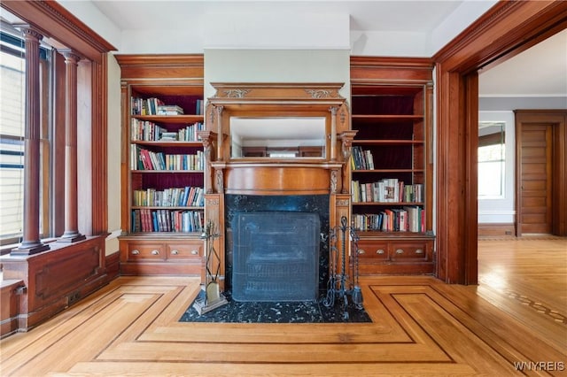 82 Clinton St, Tonawanda-City, NY 14150 - sitting room with a premium fireplace, built in shelves, baseboards, and ornamental molding