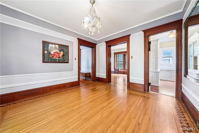 82 Clinton St, Tonawanda-City, NY 14150 - empty room featuring a chandelier, light wood finished floors, and crown molding
