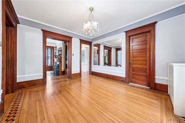 82 Clinton St, Tonawanda-City, NY 14150 - spare room with a chandelier, baseboards, light wood-style floors, and ornamental molding