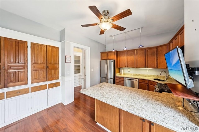 82 Clinton St, Tonawanda-City, NY 14150 - kitchen featuring stainless steel appliances, a sink, a peninsula, ceiling fan, and brown cabinetry