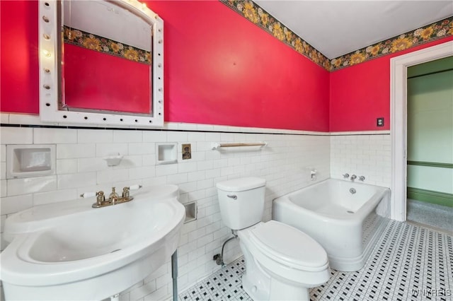 82 Clinton St, Tonawanda-City, NY 14150 - bathroom featuring a wainscoted wall, a bath, toilet, tile walls, and a sink