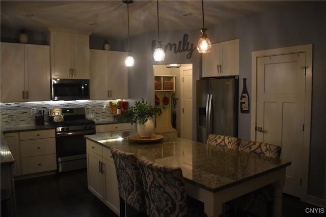 5546 Rolling Meadows Way, Camillus, NY 13031 - kitchen with appliances with stainless steel finishes, a kitchen island, backsplash, white cabinets, and dark stone countertops