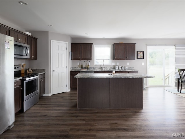 36395 Sarah Ln, Orleans, NY 13656 - kitchen featuring stainless steel appliances, dark brown cabinets, a center island, dark wood-type flooring, and plenty of natural light