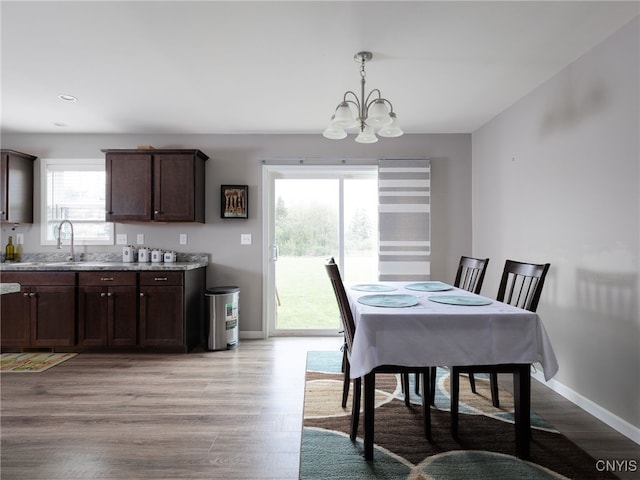 36395 Sarah Ln, Orleans, NY 13656 - dining area with a chandelier, light wood-type flooring, and baseboards