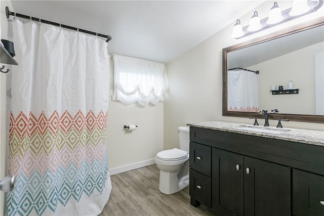 full bath with wood finished floors, toilet, vanity, baseboards, and curtained shower