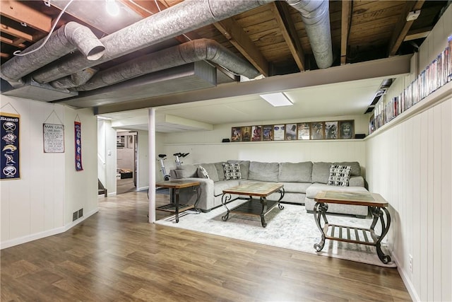 living area with wood finished floors and baseboards