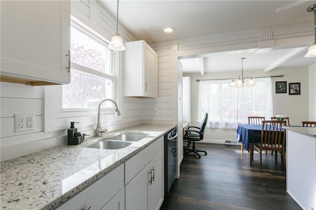 kitchen featuring a sink, beam ceiling, dark wood-type flooring, plenty of natural light, and black dishwasher