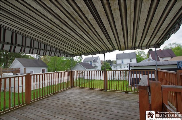 wooden deck with a shed, an outbuilding, and a residential view