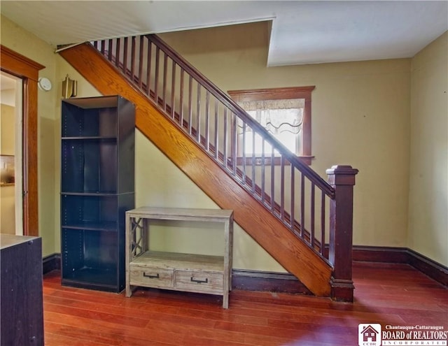 staircase with hardwood / wood-style flooring and baseboards