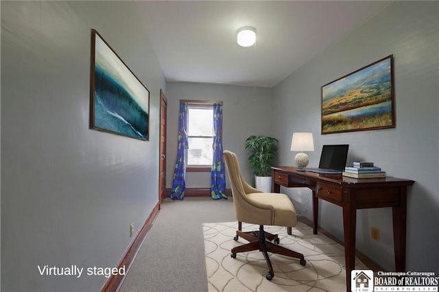 carpeted office space with baseboards