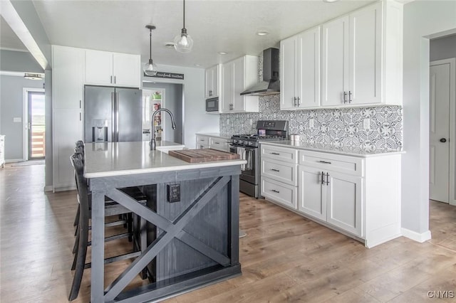 29556 County Route 46, Le Ray, NY 13637 - kitchen with wall chimney range hood, stainless steel appliances, backsplash, light countertops, and white cabinetry