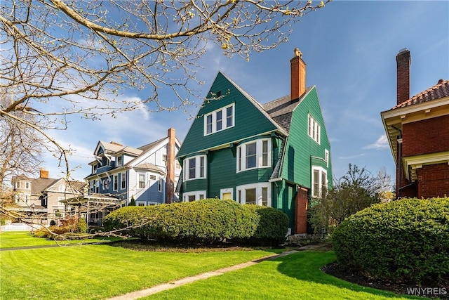 47 Beard Ave, Buffalo, NY 14214 - view of front of house with a residential view, a front yard, and a chimney