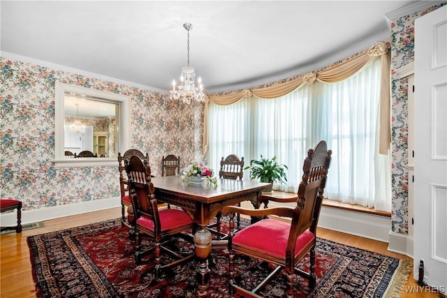 47 Beard Ave, Buffalo, NY 14214 - dining room with a chandelier, plenty of natural light, wallpapered walls, baseboards, and wood finished floors