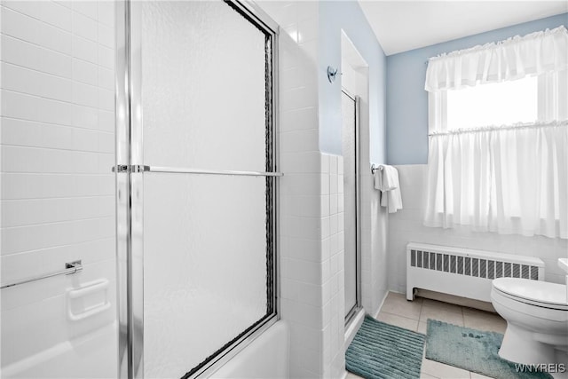 47 Beard Ave, Buffalo, NY 14214 - full bath with radiator, toilet, a shower with door, tile walls, and tile patterned floors