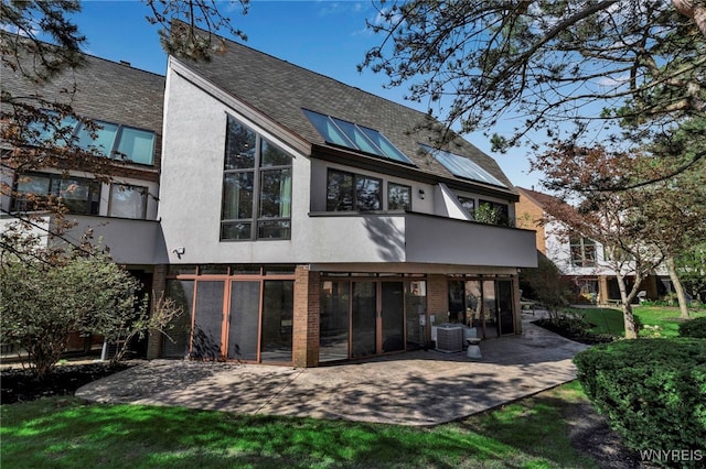 20 Harbour Pointe, Buffalo, NY 14202 - rear view of property with a patio, a sunroom, central air condition unit, stucco siding, and brick siding