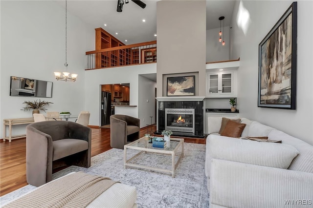 20 Harbour Pointe, Buffalo, NY 14202 - living room with a high ceiling, wood finished floors, a chandelier, a fireplace, and recessed lighting