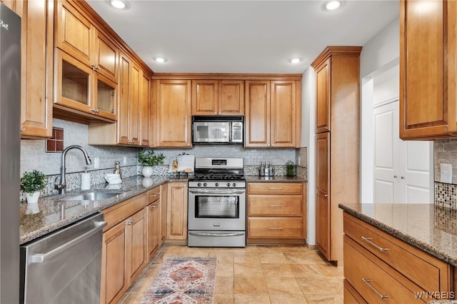 20 Harbour Pointe, Buffalo, NY 14202 - kitchen featuring appliances with stainless steel finishes, a sink, tasteful backsplash, dark stone counters, and recessed lighting