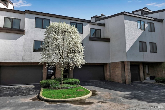 20 Harbour Pointe, Buffalo, NY 14202 - multi unit property featuring brick siding, a garage, stucco siding, and driveway
