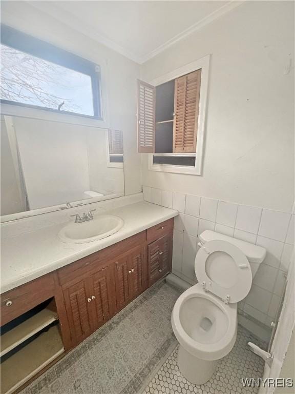 66 Northrup Pl, Buffalo, NY 14214 - bathroom featuring crown molding, vanity, toilet, tile walls, and tile patterned flooring
