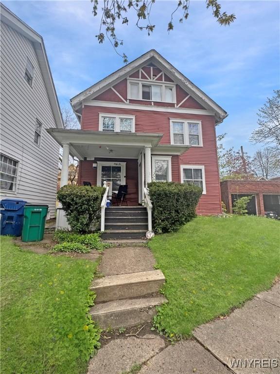 66 Northrup Pl, Buffalo, NY 14214 - view of front of property featuring covered porch and a front lawn