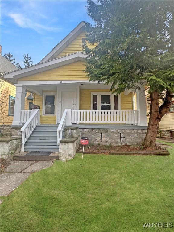 75 Northrup Pl, Buffalo, NY 14214 - view of front of home featuring covered porch and a front lawn