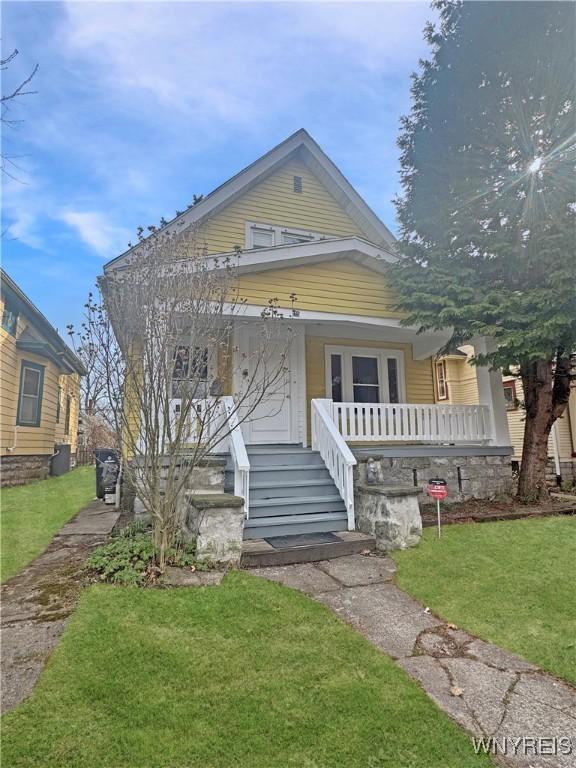 75 Northrup Pl, Buffalo, NY 14214 - bungalow with covered porch and a front yard