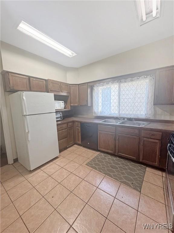 75 Northrup Pl, Buffalo, NY 14214 - kitchen featuring freestanding refrigerator, dishwasher, a sink, and light tile patterned flooring