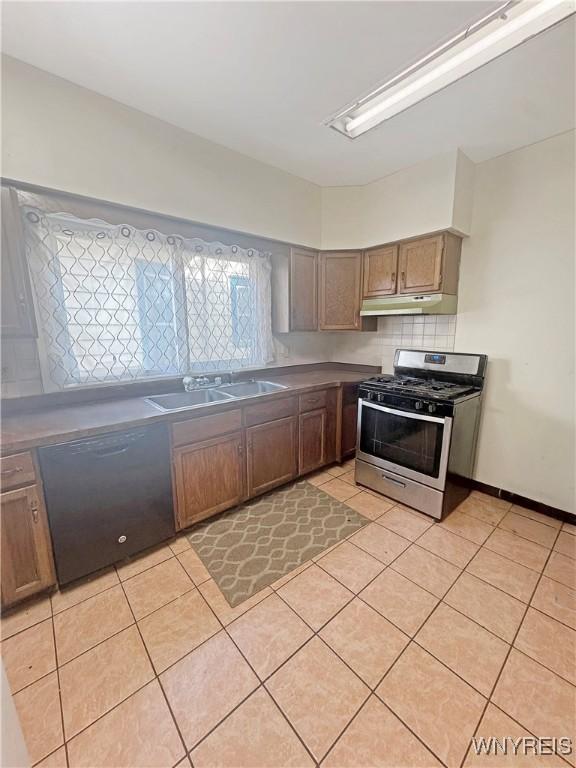75 Northrup Pl, Buffalo, NY 14214 - kitchen with stainless steel gas range, black dishwasher, a sink, light tile patterned flooring, and under cabinet range hood
