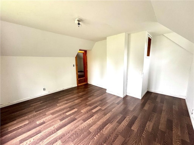 bonus room with vaulted ceiling, wood finished floors, and baseboards