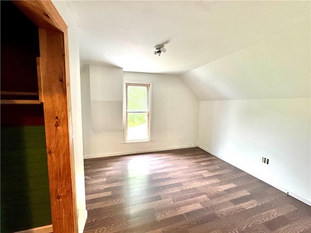 bonus room featuring wood finished floors, vaulted ceiling, and baseboards