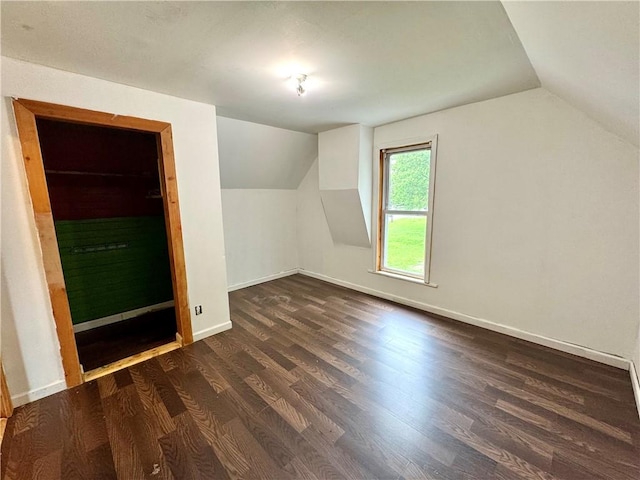 additional living space featuring lofted ceiling, wood finished floors, and baseboards
