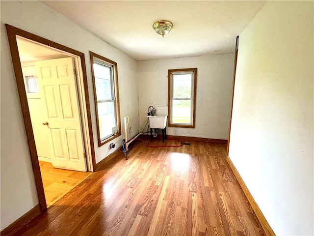 unfurnished room featuring light wood finished floors and baseboards