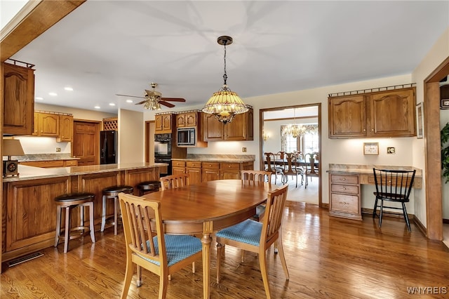 dining room with wood finished floors, recessed lighting, a chandelier, and ceiling fan