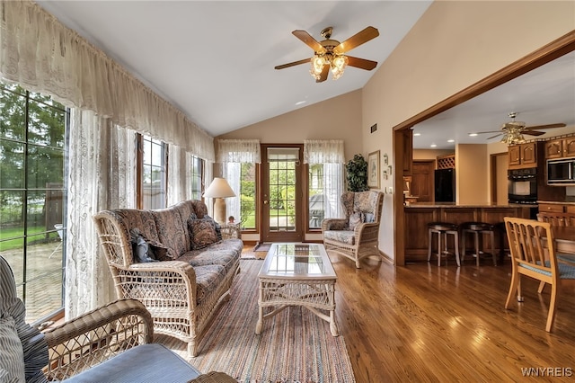 living room featuring ceiling fan, wood finished floors, and high vaulted ceiling