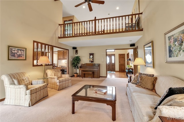 carpeted living room featuring a towering ceiling, ceiling fan, recessed lighting, and baseboards