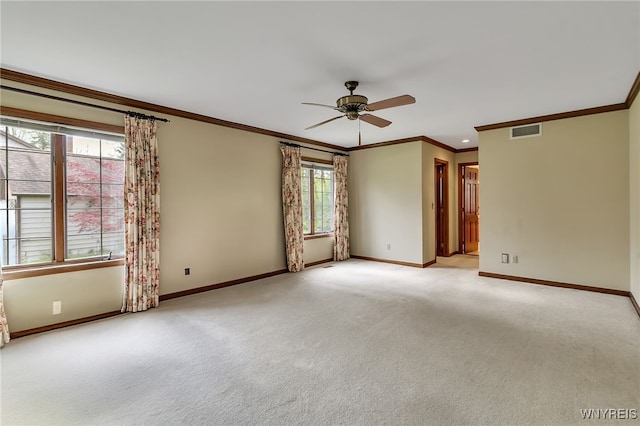 unfurnished room featuring baseboards, a ceiling fan, ornamental molding, and light carpet