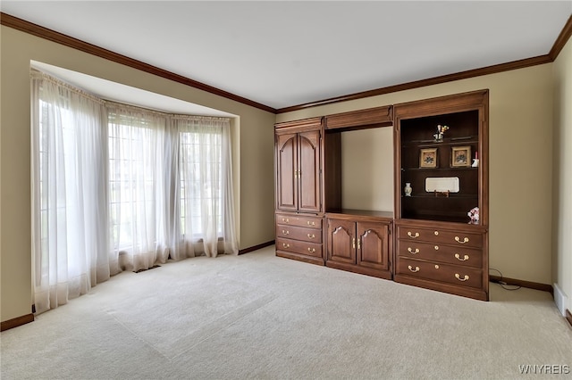 unfurnished bedroom featuring baseboards, light carpet, and crown molding