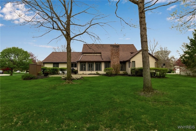 back of property featuring a lawn and a chimney